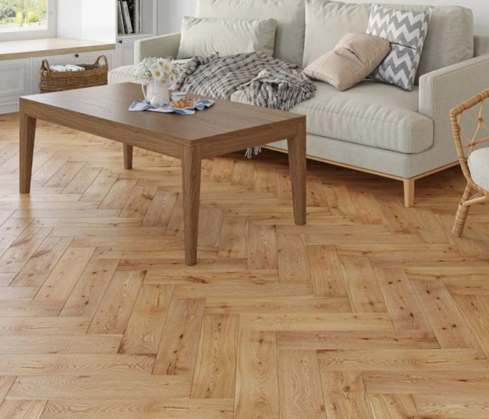 Light oak herringbone wood flooring in a modern living room.