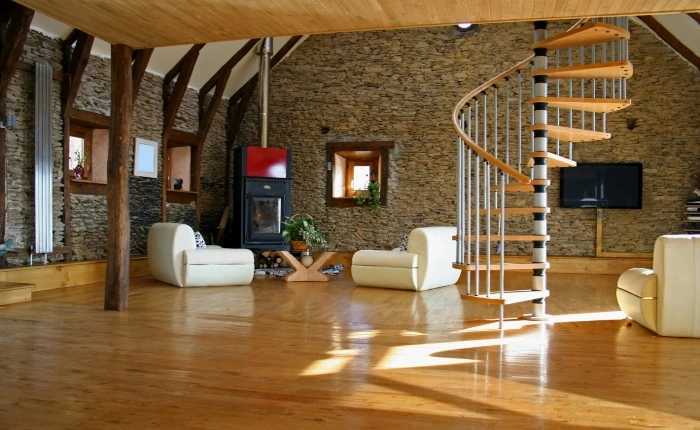 Modern wood flooring in a rustic stone living room.